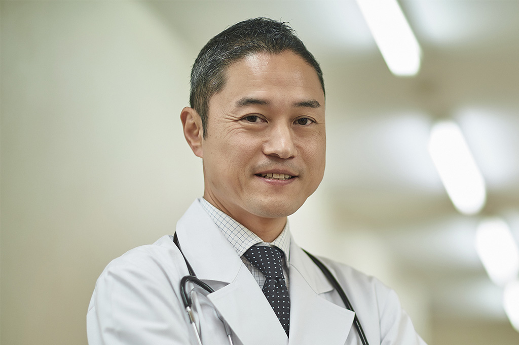 A male doctor in lab coat with graying hair