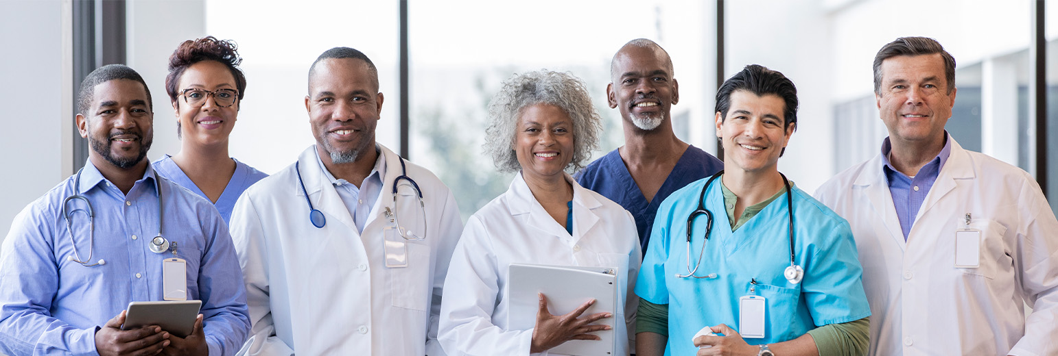 A team of smiling doctors and nurses