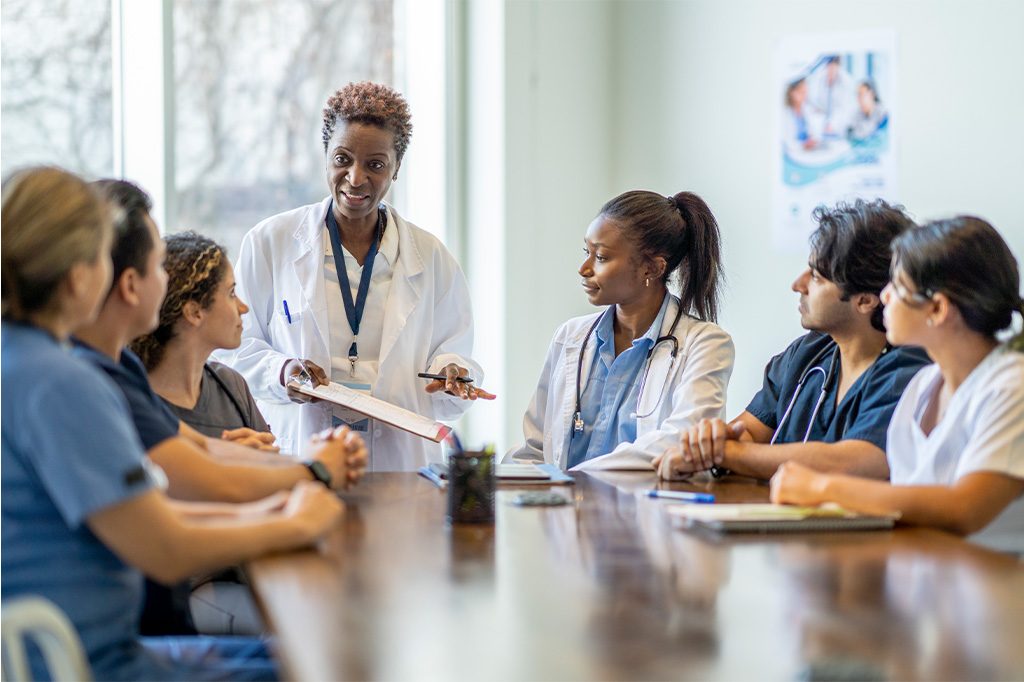 A team of doctors have a meeting in a conference room