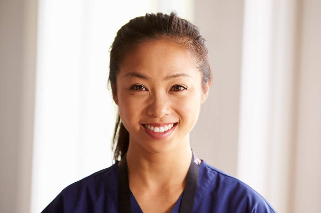A smiling nurse in scrubs